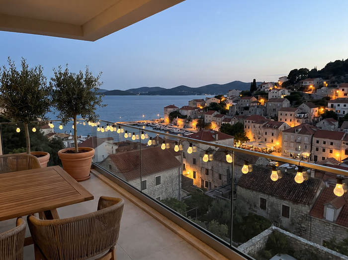 Modern apartment balcony overlooking St Julian's coastline at dusk